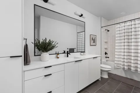 a bathroom with a sink and a large mirror