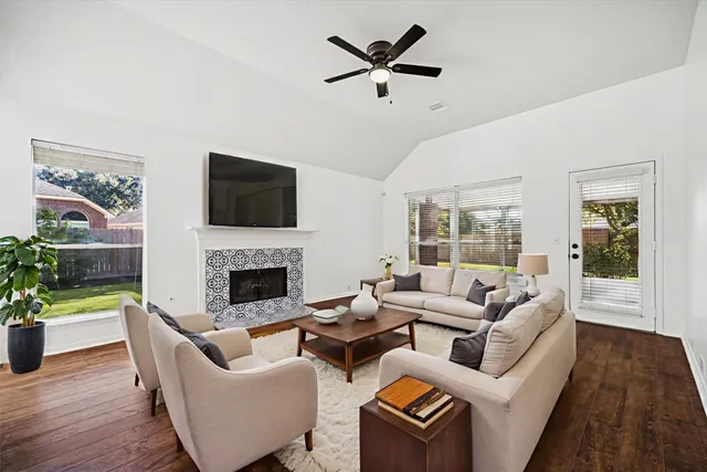 a living room with furniture a fireplace and a flat screen tv