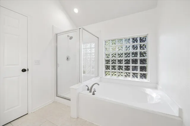 a bathroom with a bathtub and a shower