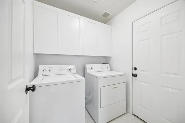 a view of storage and utility room with washer and dryer