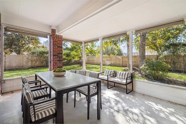 a view of a dining room with furniture large windows and wooden floor