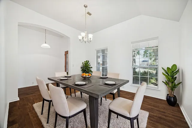a view of a dining room with furniture window and wooden floor