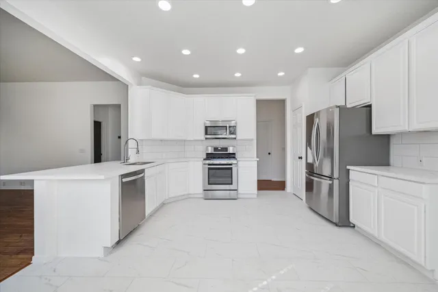 a kitchen with refrigerator cabinets and stainless steel appliances