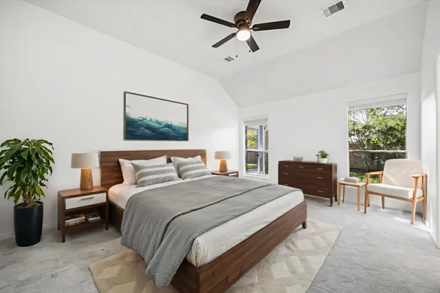 a bed room with a bed and a chair