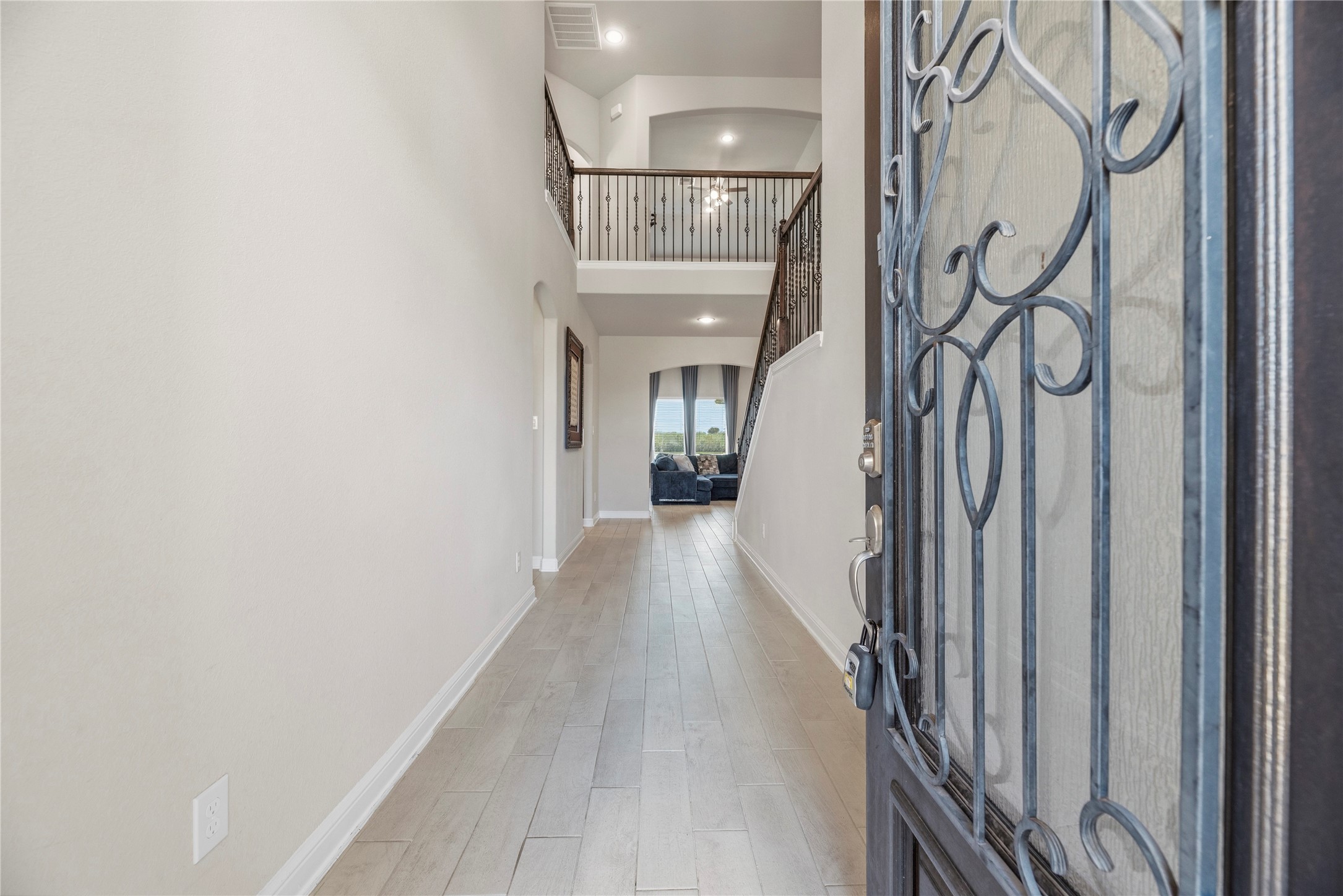 3319 Learning Tree Lane Rosenberg, TX 77471 - Photo 2 of 44 a view of a hallway with wooden floor and entryway