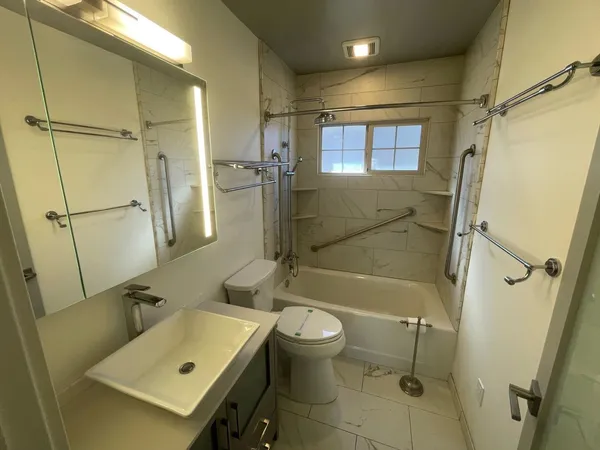 a bathroom with a sink toilet and shower