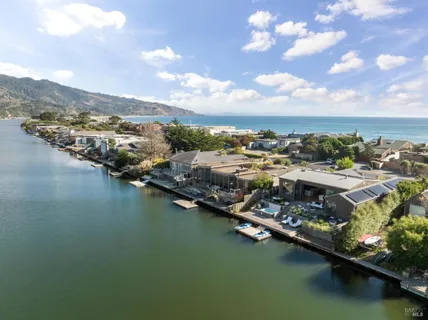an aerial view of residential houses with lake view