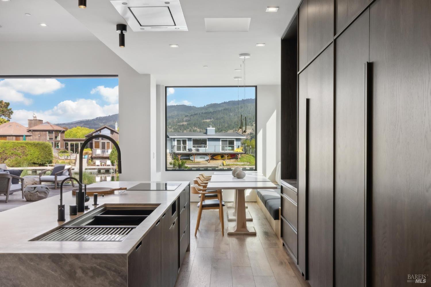 297 Seadrift Road Stinson Beach, CA 94970 - Photo 14 of 44 a kitchen with stainless steel appliances a stove sink and cabinets