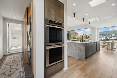 a kitchen with stainless steel appliances a refrigerator and a stove top oven