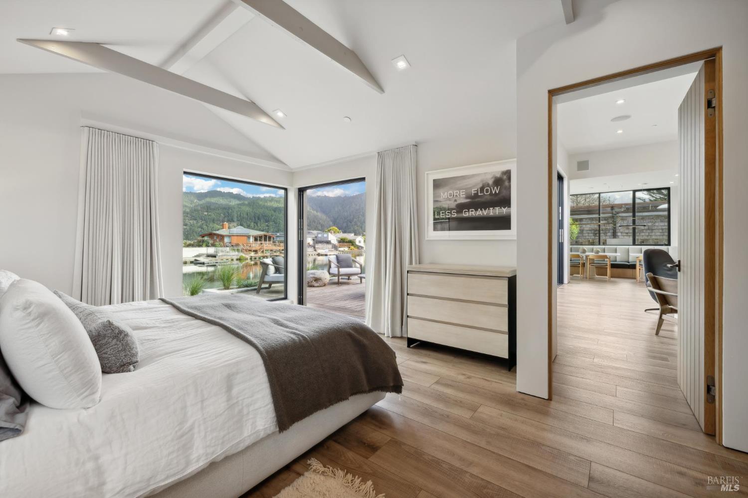 297 Seadrift Road Stinson Beach, CA 94970 - Photo 17 of 44 a bedroom with a balcony a bed and wooden floor