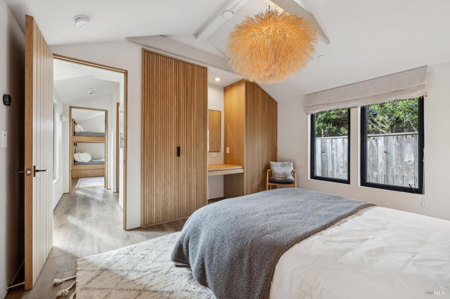 297 Seadrift Road Stinson Beach, CA 94970 - Photo 18 of 44 a bedroom with a large bed and a chandelier