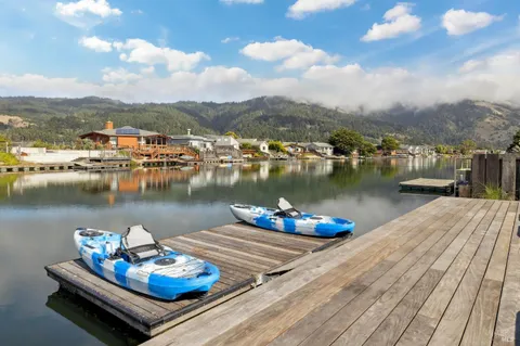 a view of a lake with couches chairs