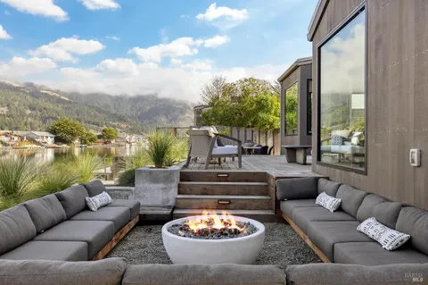 a view of a patio with couches chairs and a potted plant