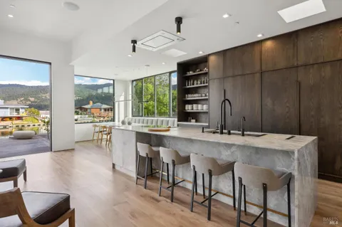a large kitchen with a table and chairs