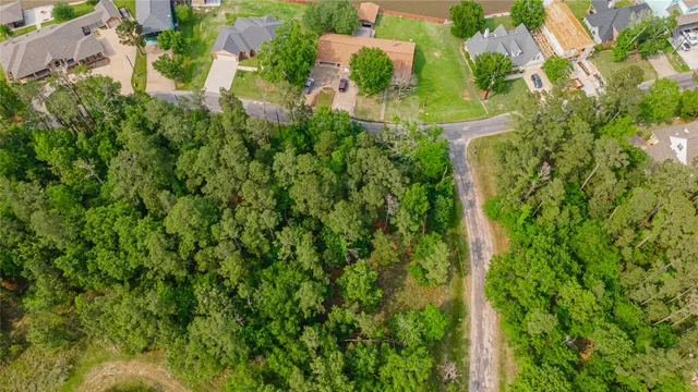an aerial view of residential house with outdoor space and trees all around