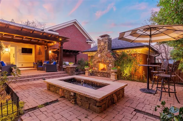a view of a patio with a table and chairs under an umbrella