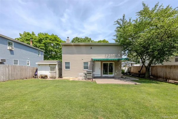a front view of house with yard and outdoor seating