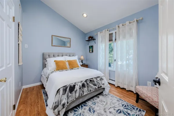 a bedroom with a bed and a mirror