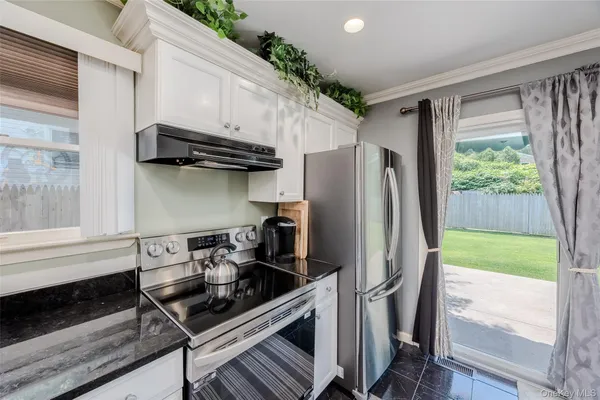 a kitchen with stainless steel appliances a refrigerator and a stove