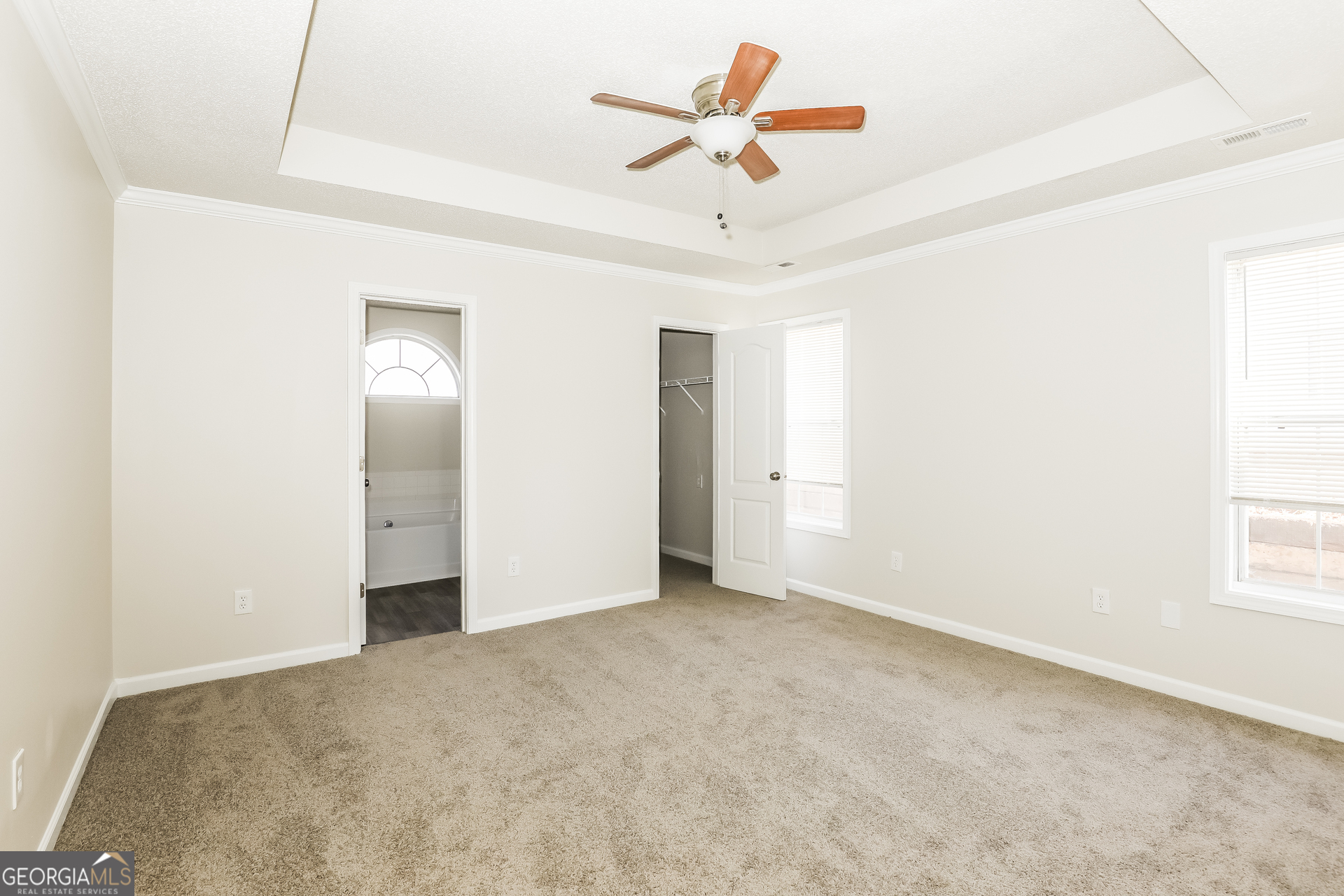 1915 Portwest Way Hampton, GA 30228 - Photo 7 of 16 an empty room with a ceiling fan and window