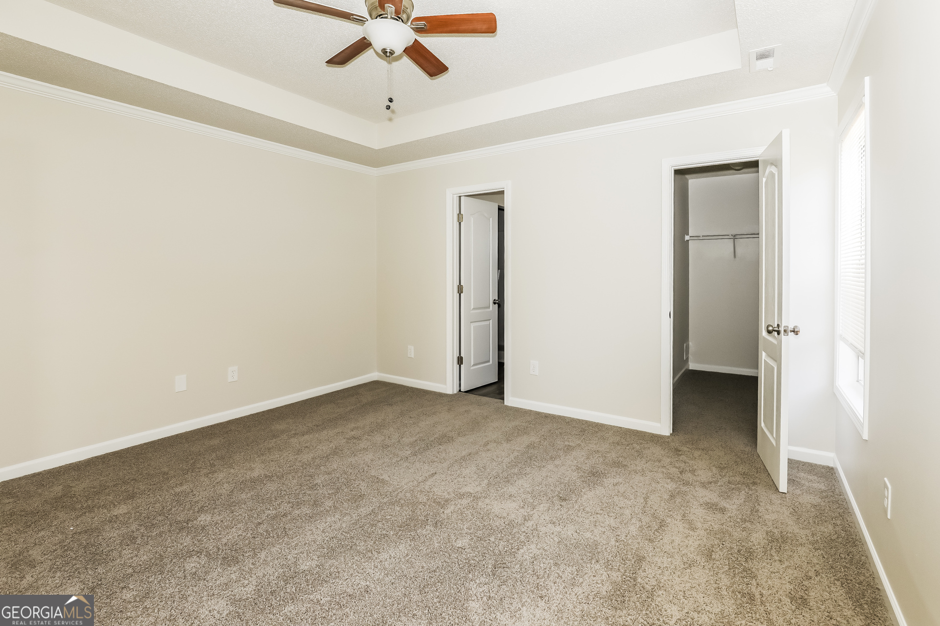 1915 Portwest Way Hampton, GA 30228 - Photo 8 of 16 an empty room with a ceiling fan and a window