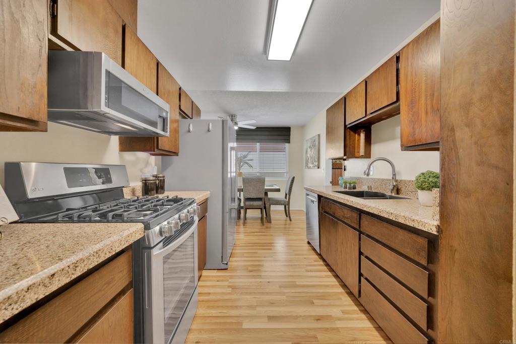 9430 Lake Canyon Road Santee, CA 92071 - Photo 13 of 52 a kitchen with stainless steel appliances granite countertop a stove and a sink