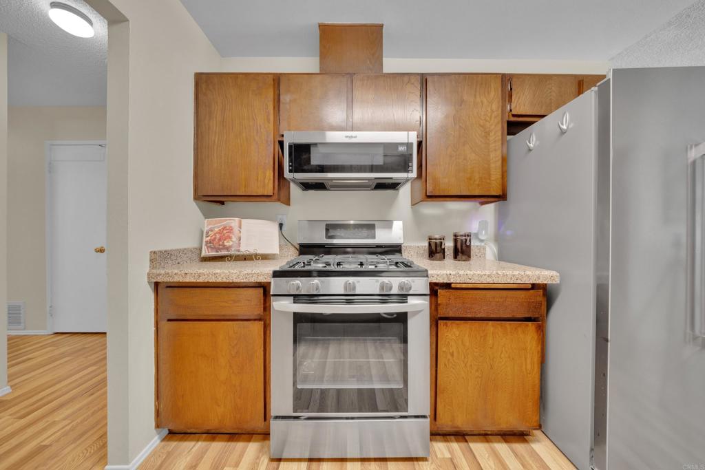 9430 Lake Canyon Road Santee, CA 92071 - Photo 16 of 52 a kitchen with a stove and a refrigerator