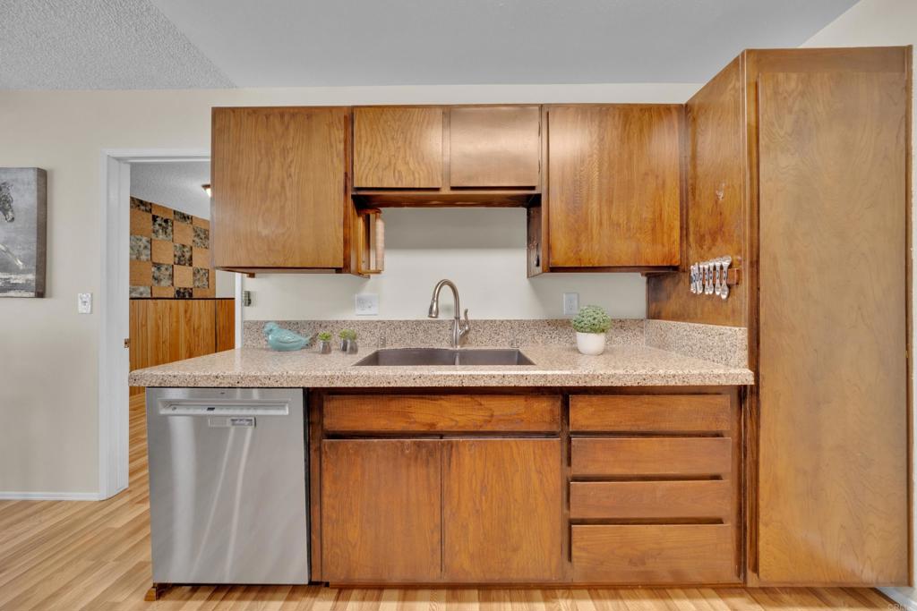 9430 Lake Canyon Road Santee, CA 92071 - Photo 17 of 52 a kitchen with stainless steel appliances granite countertop wooden cabinets and a sink