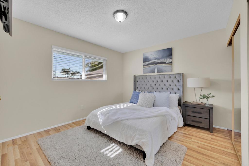 9430 Lake Canyon Road Santee, CA 92071 - Photo 23 of 52 a bedroom with a bed and a lamp on dresser