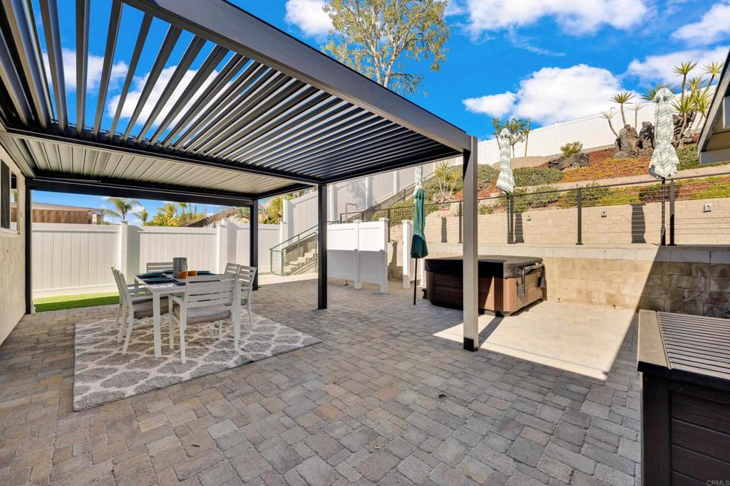 9430 Lake Canyon Road Santee, CA 92071 - Photo 44 of 52 a view of a patio with table and chairs with wooden floor and fence
