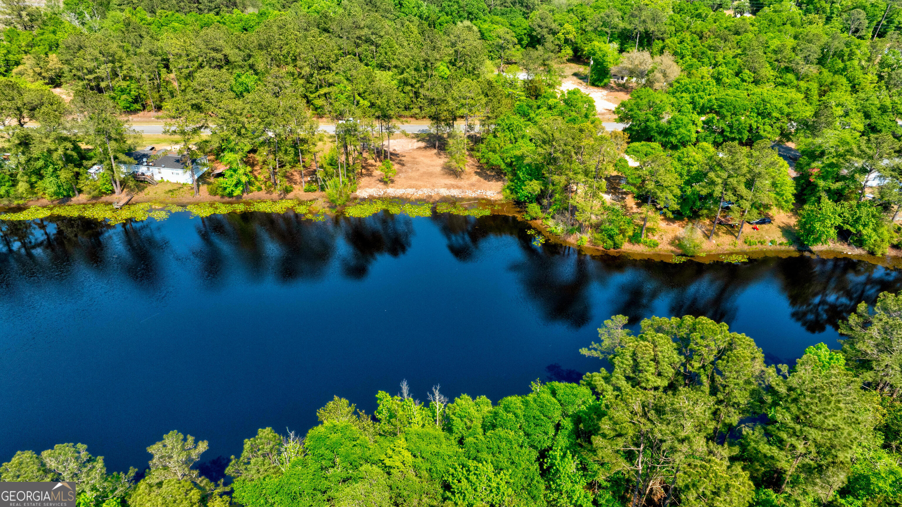 111 Edgewater Drive Bloomingdale, GA 31302 - Photo 5 of 11 a view of a lake with a yard
