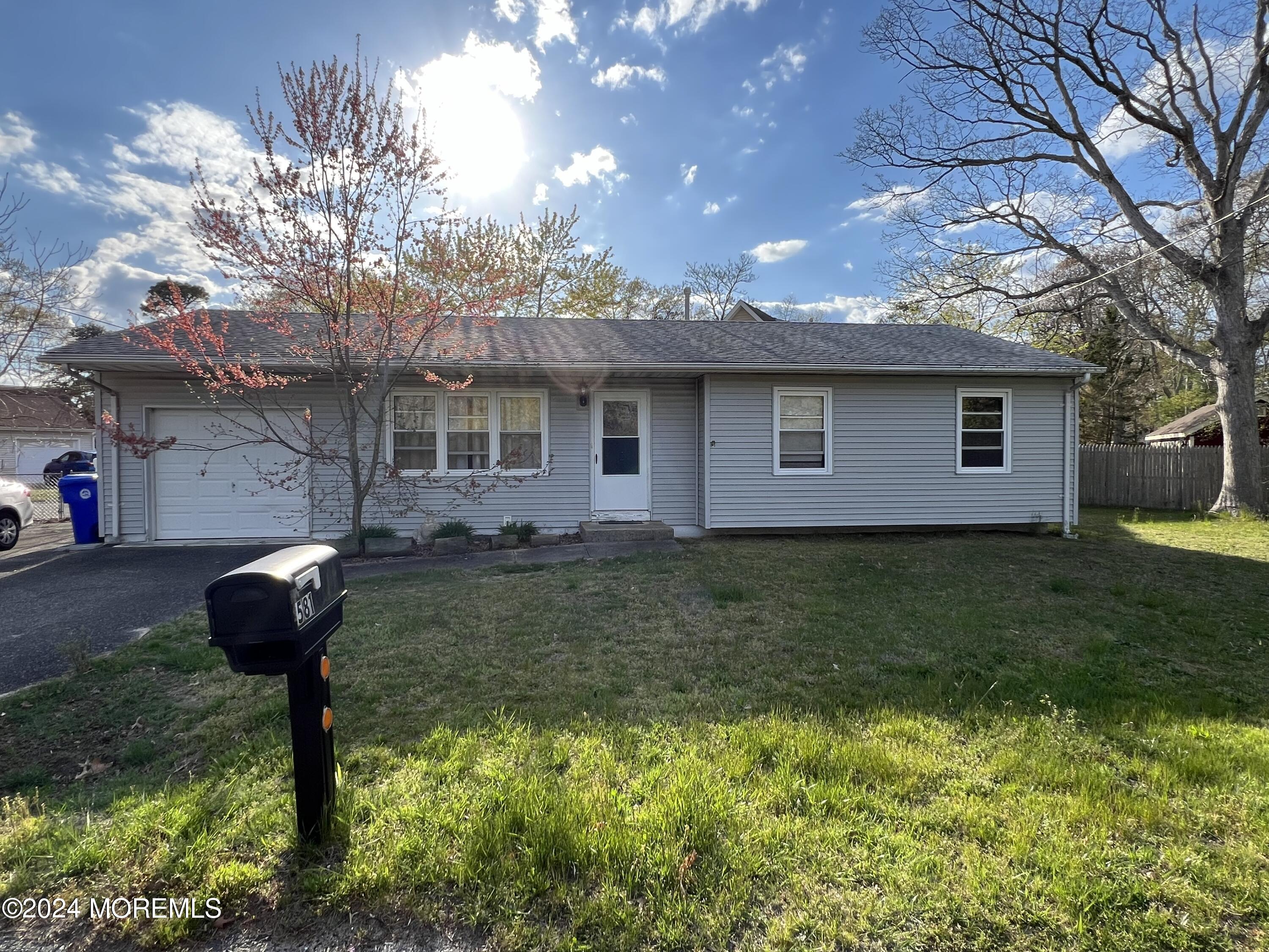 581 Drum Point Road Brick, NJ 08723 - Photo 2 of 6 a front view of a house with garden