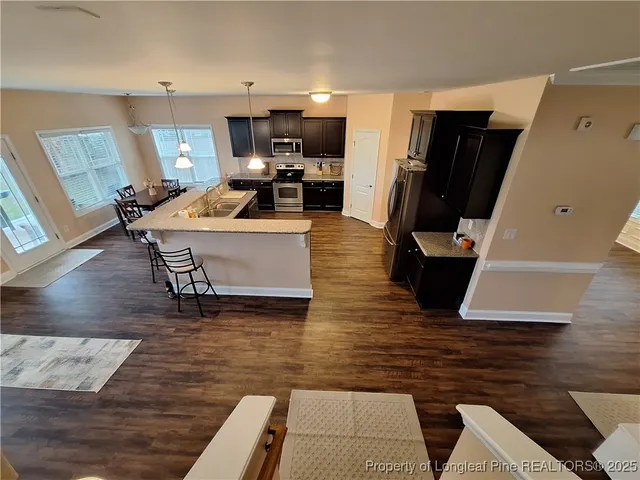 a view of a livingroom with furniture and wooden floor