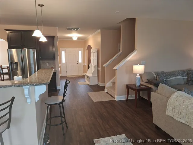 a kitchen with stainless steel appliances granite countertop a sink a stove and a refrigerator