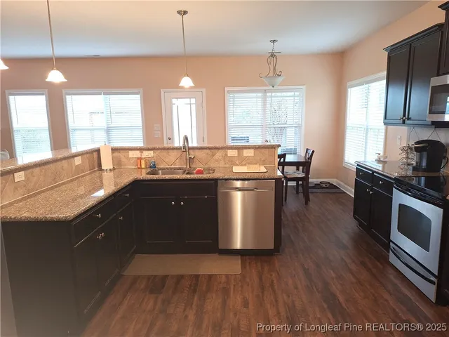 a view of a dining room with furniture and wooden floor