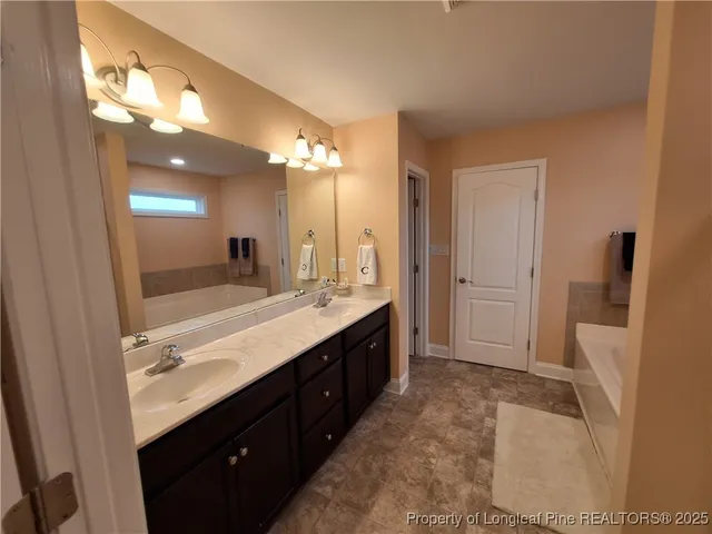 a bathroom with a bathtub and a window