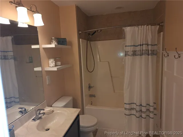 a bathroom with a shower a toilet and shower
