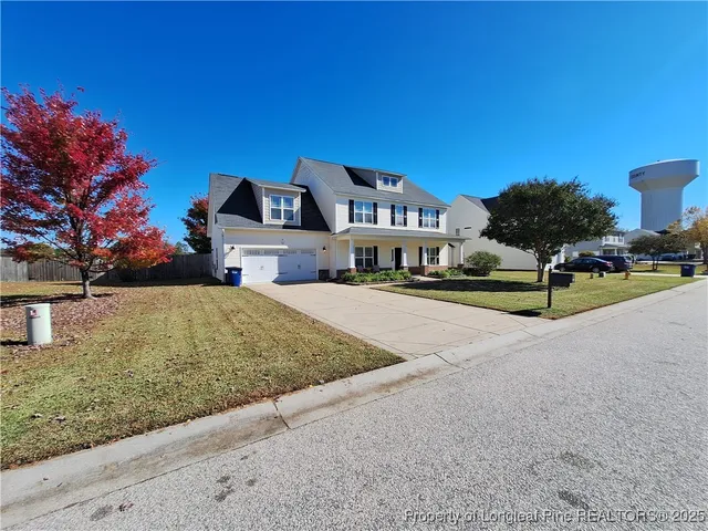 a dining room with wooden floor a chandelier a wooden table and chairs