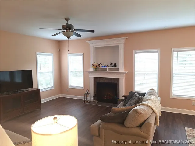 a living room with furniture a fireplace and a flat screen tv