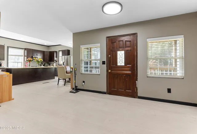 a view of a livingroom with furniture and a flat screen tv