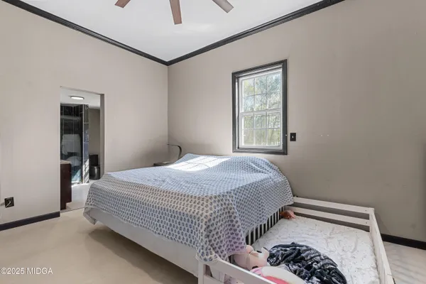 a bedroom with a bed and a window