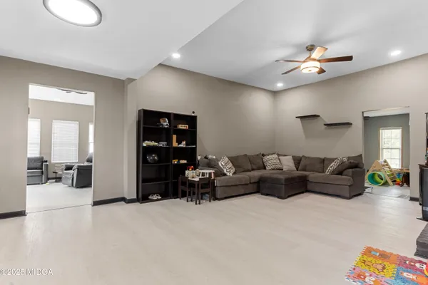 a living room with furniture and a chandelier