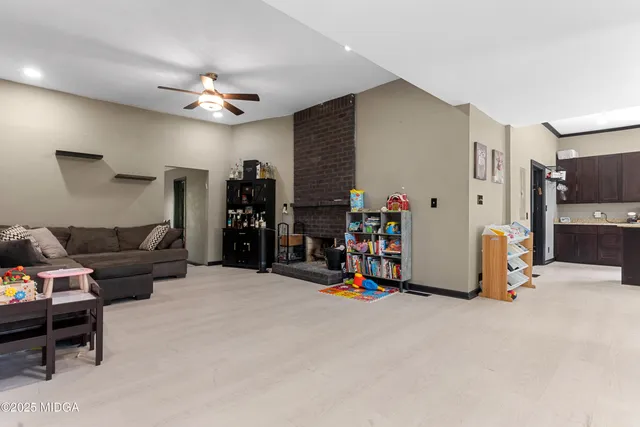 a kitchen with stainless steel appliances granite countertop a sink refrigerator and cabinets