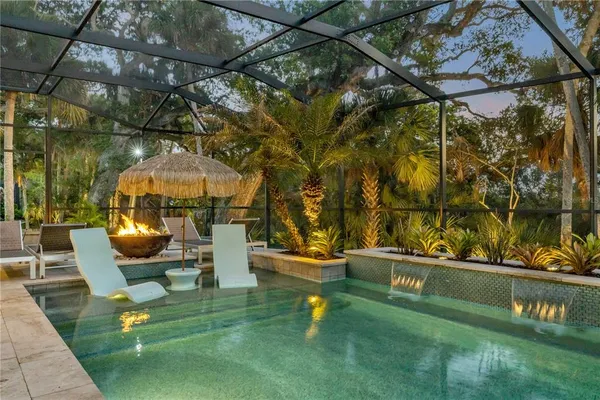 a view of a patio with couches table and chairs and potted plants