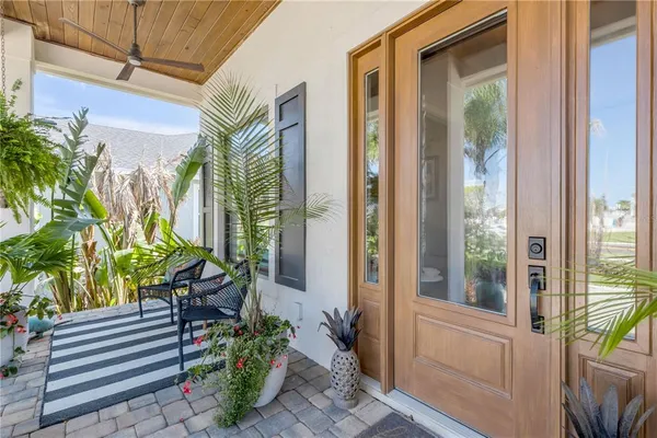 a living room with patio furniture and a floor to ceiling window