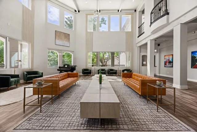 a living room with furniture rug and a chandelier