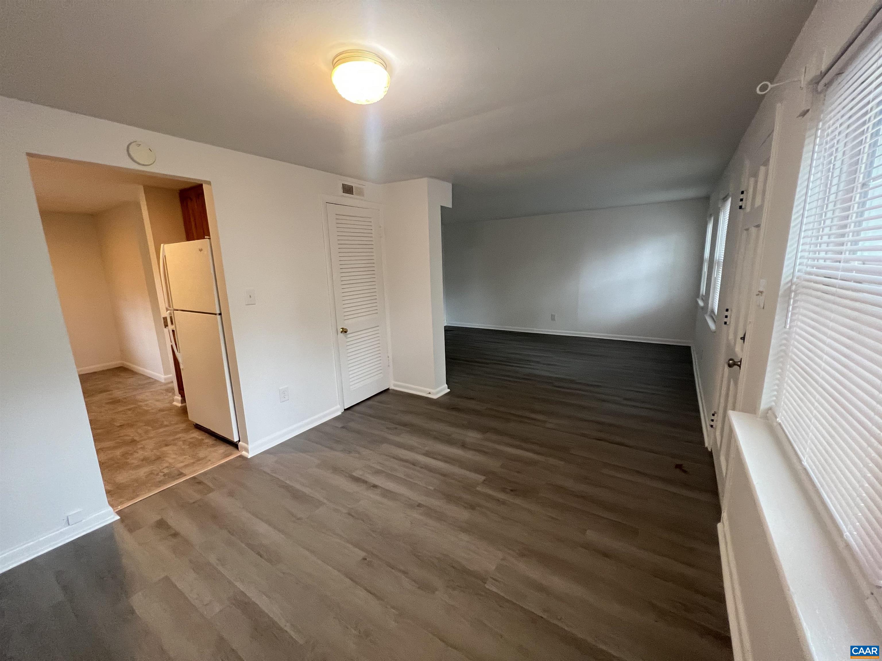 124 Middlesex Drive, Unit B Charlottesville, VA 22901 - Photo 11 of 38 an empty room with wooden floor and a window
