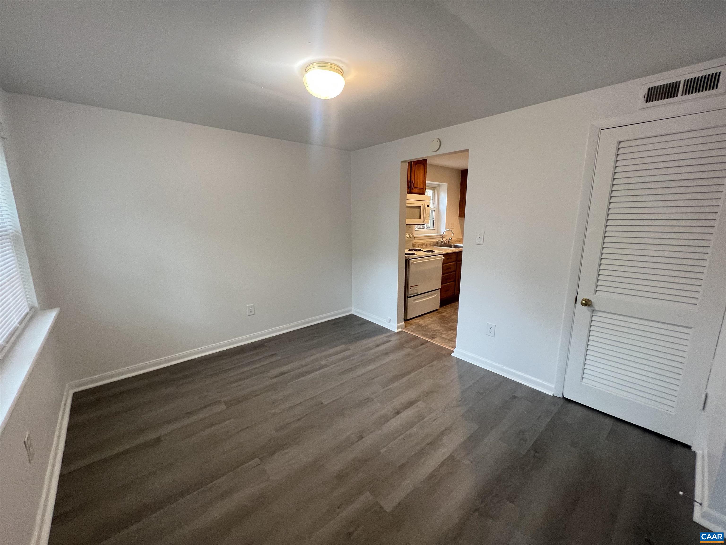 124 Middlesex Drive, Unit B Charlottesville, VA 22901 - Photo 12 of 38 a view of an empty room with wooden floor and closet