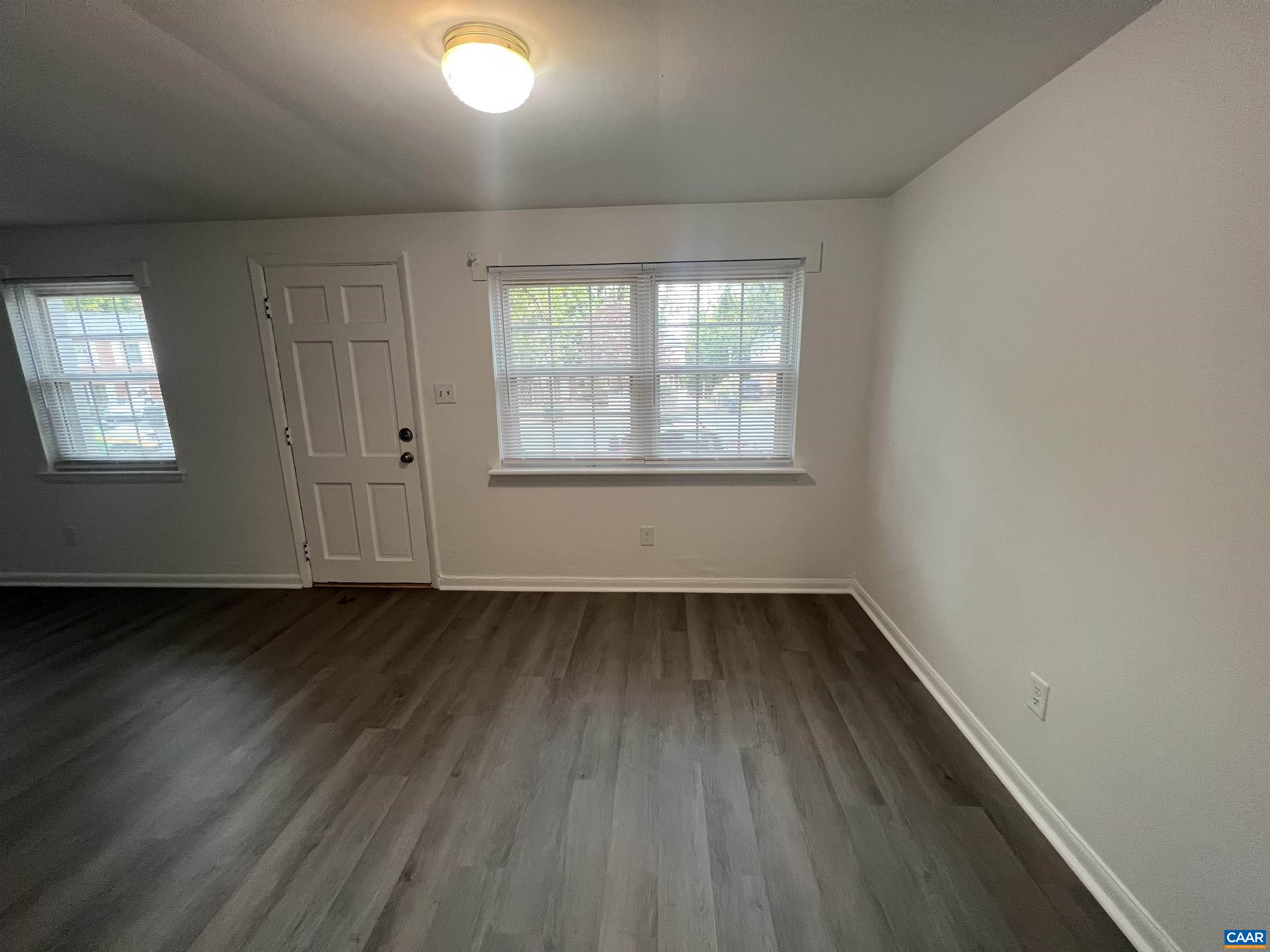 124 Middlesex Drive, Unit B Charlottesville, VA 22901 - Photo 13 of 38 an empty room with wooden floor and windows