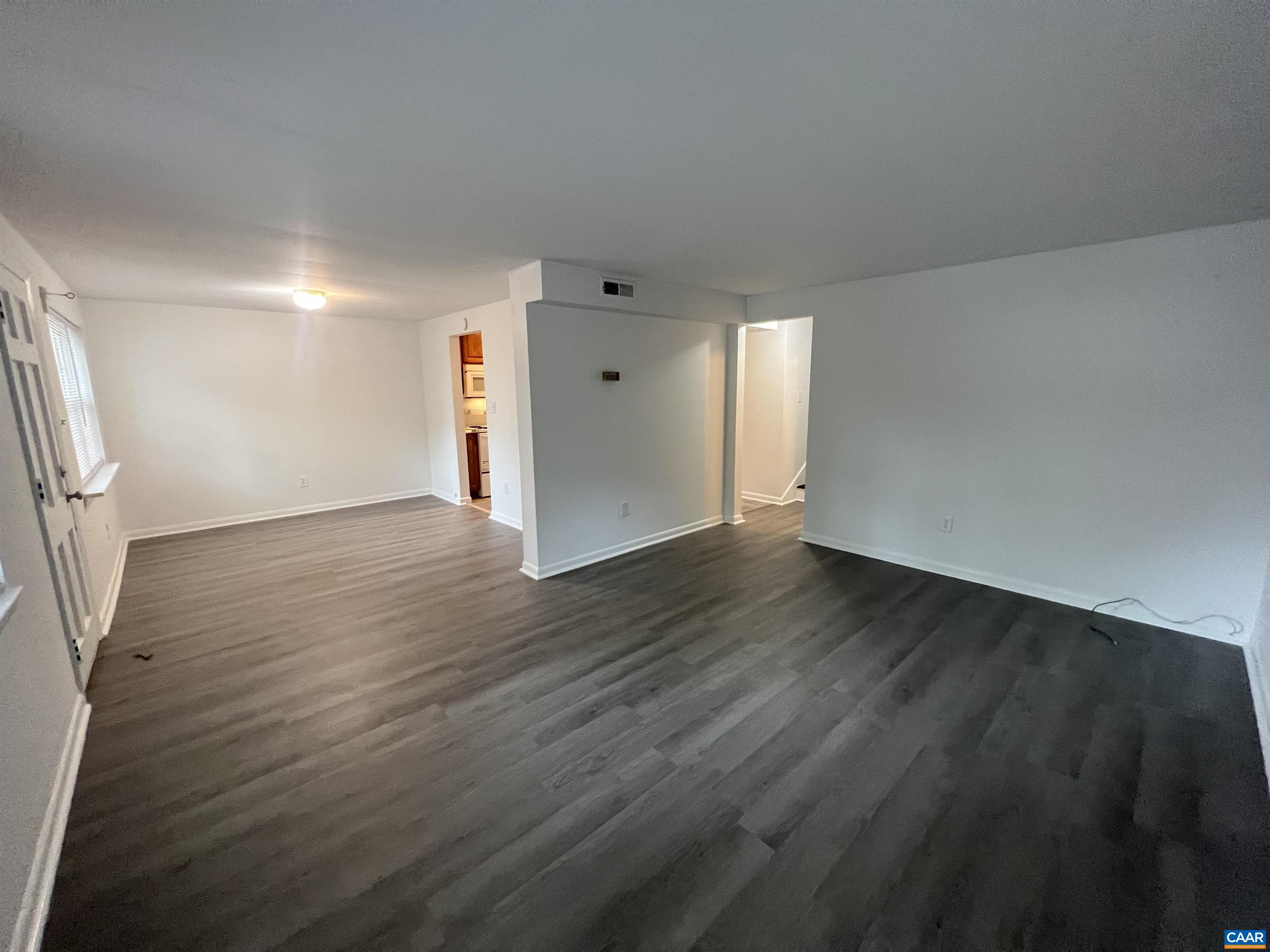 124 Middlesex Drive, Unit B Charlottesville, VA 22901 - Photo 26 of 38 an empty room with wooden floor and windows